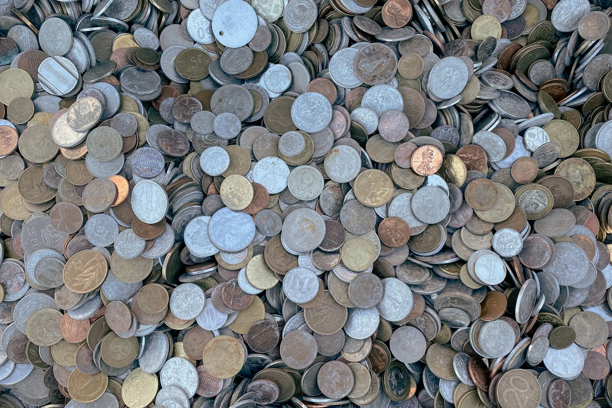 Loose coins and small cash collected in a charity donation setting, the kind of giving GASDS is designed for.