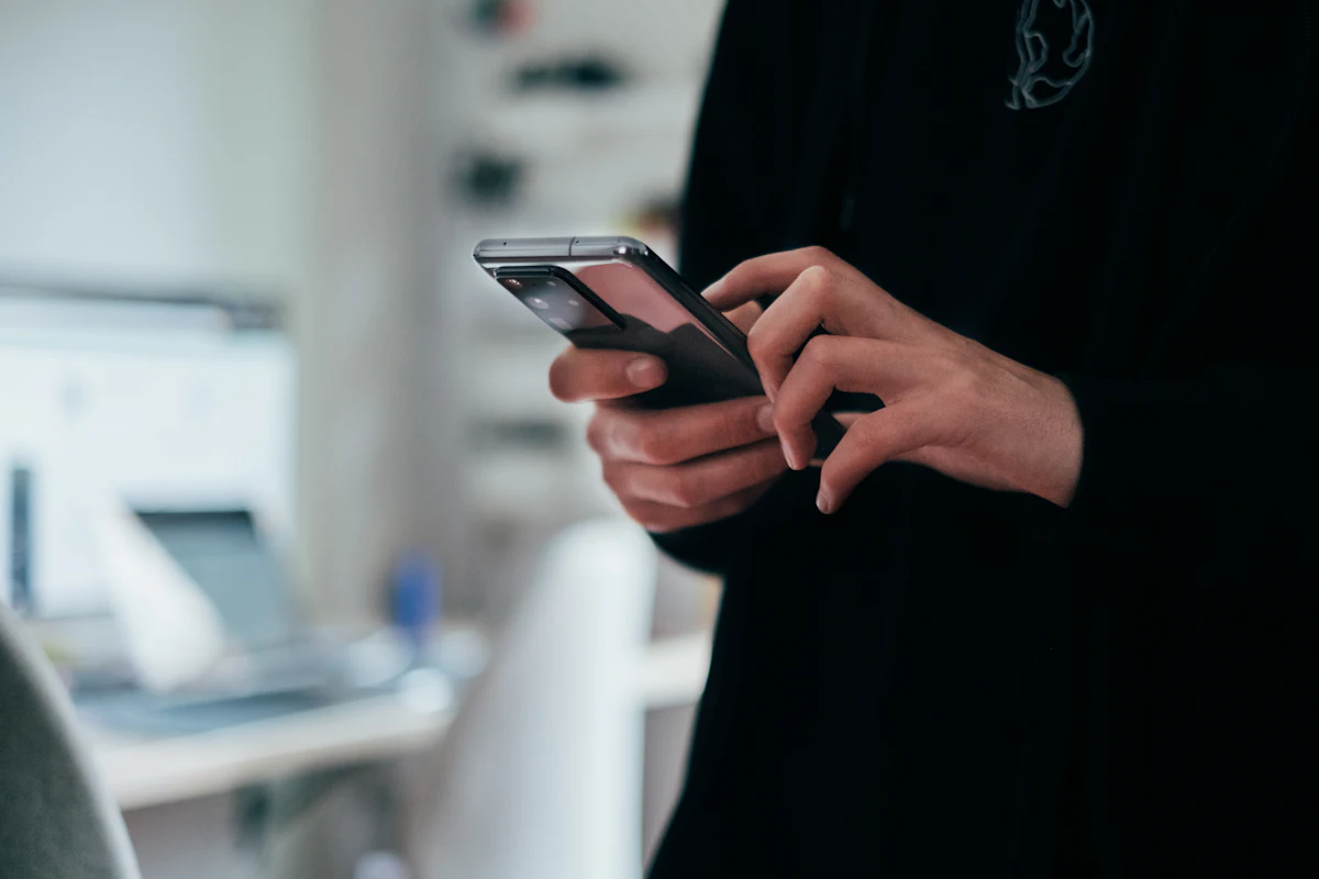A community member using a mosque website on their smartphone to check information and give.