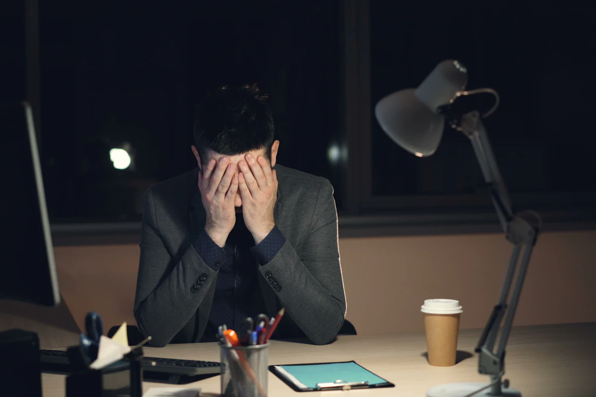 A charity finance officer reviewing donation paperwork and declarations at a desk before submitting a Gift Aid claim.